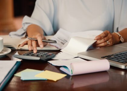 Een rommelige boekhouding met facturen, bonnetjes en financiële documenten die de noodzaak aantonen van het opschonen van de boekhouding en financiële ordening.